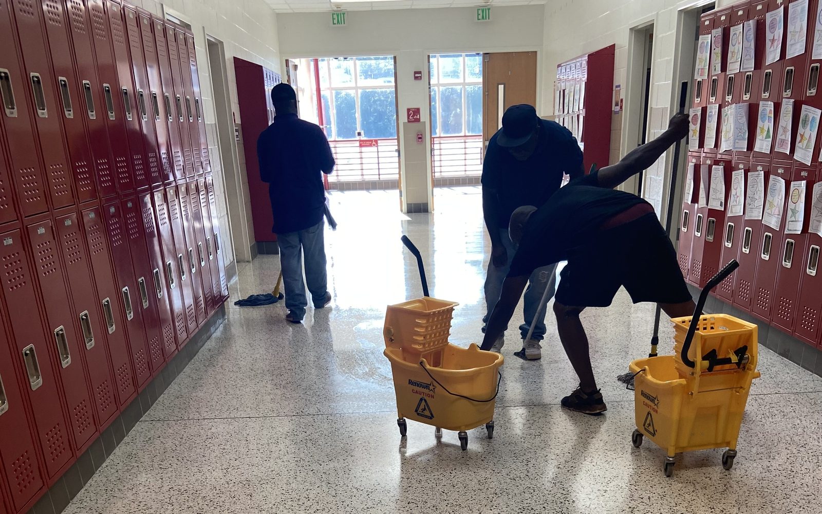 Hinsley Cleaning Group crew finishing a commercial hallway